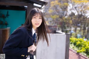 A woman in a school uniform posing for a picture.