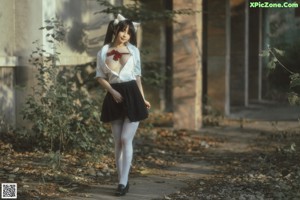 A naked woman in white stockings and a black cat tail.