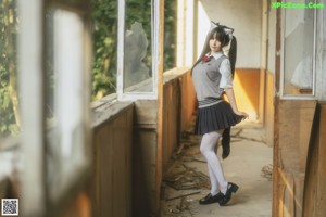 A naked woman in a white shirt and white stockings posing for the camera.