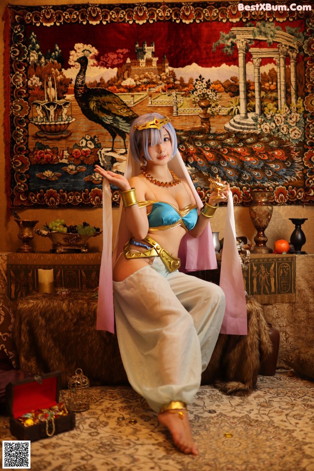 A woman in a blue and gold outfit sitting on a rug.