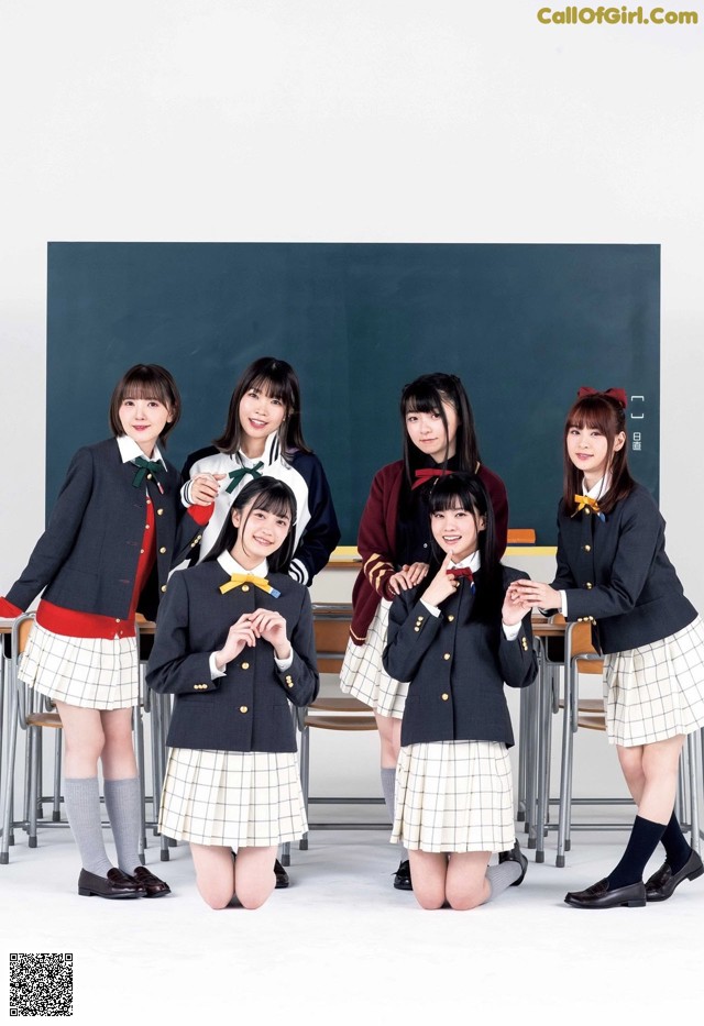 A group of young women in school uniforms posing for a picture.