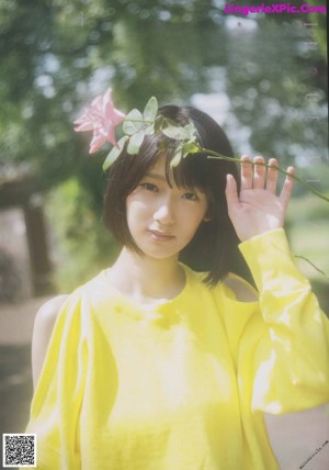 A woman in a yellow top and a white skirt.