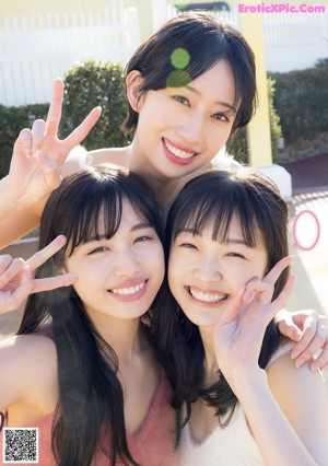 A group of young women standing next to a swimming pool.