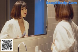 A woman in a blue panties posing in a bathroom.