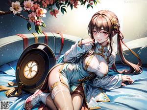 A woman in a blue dress sitting on a bed.