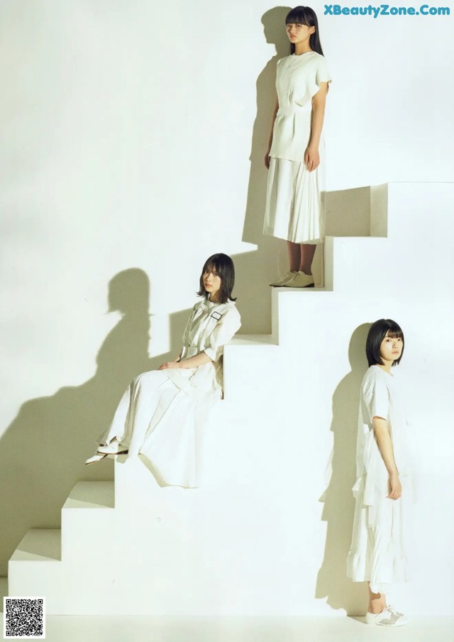 A group of three women sitting on a set of stairs.