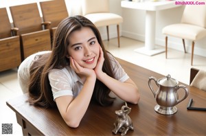 A woman in a pink sweater posing for a picture.