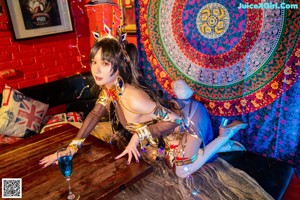A woman in a costume sitting on the floor.