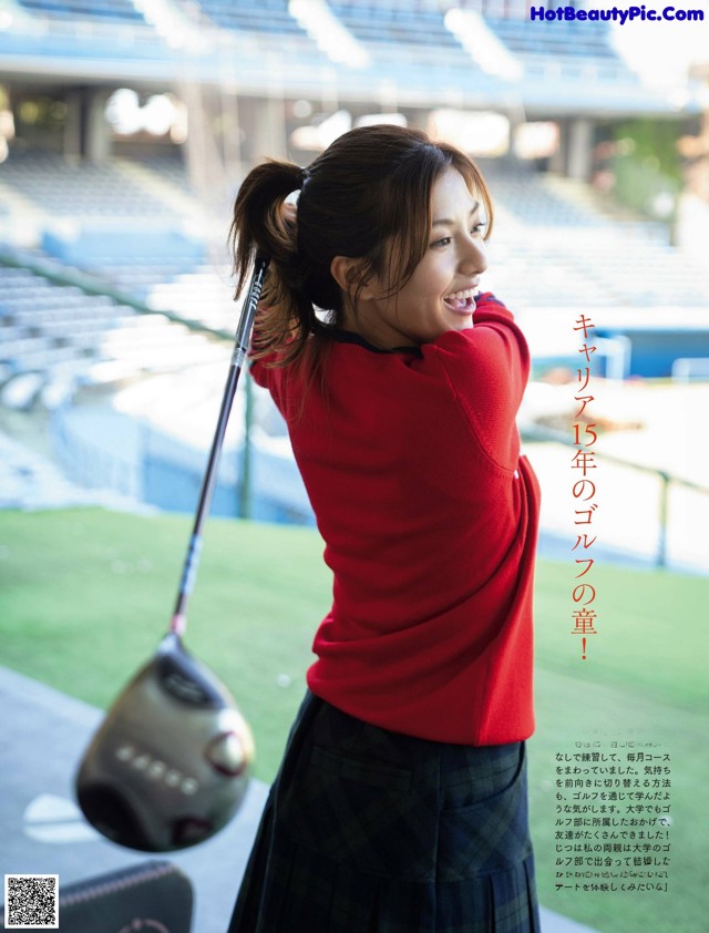 A woman in a red sweater and plaid skirt holding a golf club.