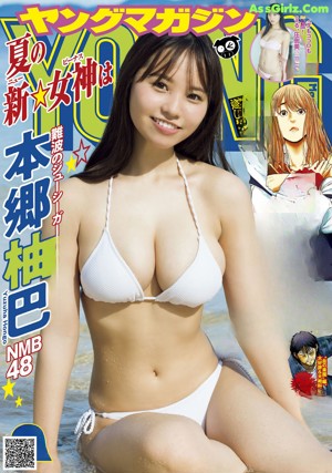 A woman in a brown bikini sitting in the water.