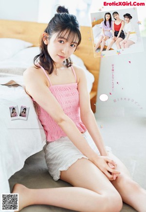 A young woman in a school uniform posing for a picture.