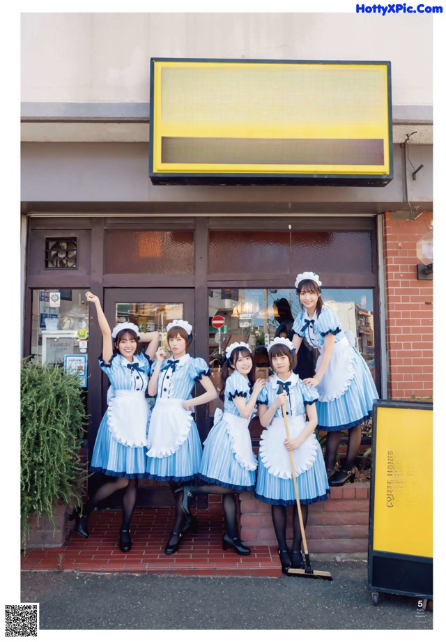 A group of women standing in front of a coffee house.