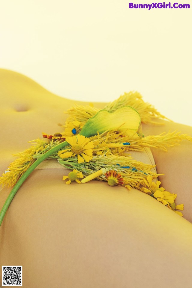 A close up of a woman's butt with a bunch of flowers on it.